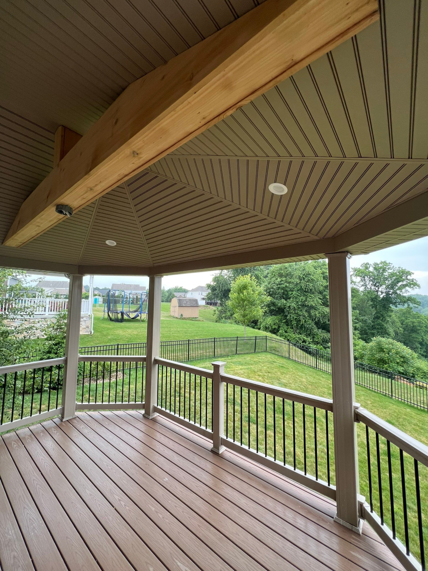 Finished covered deck with beadboard ceiling, recessed lighting and exposed cedar beam