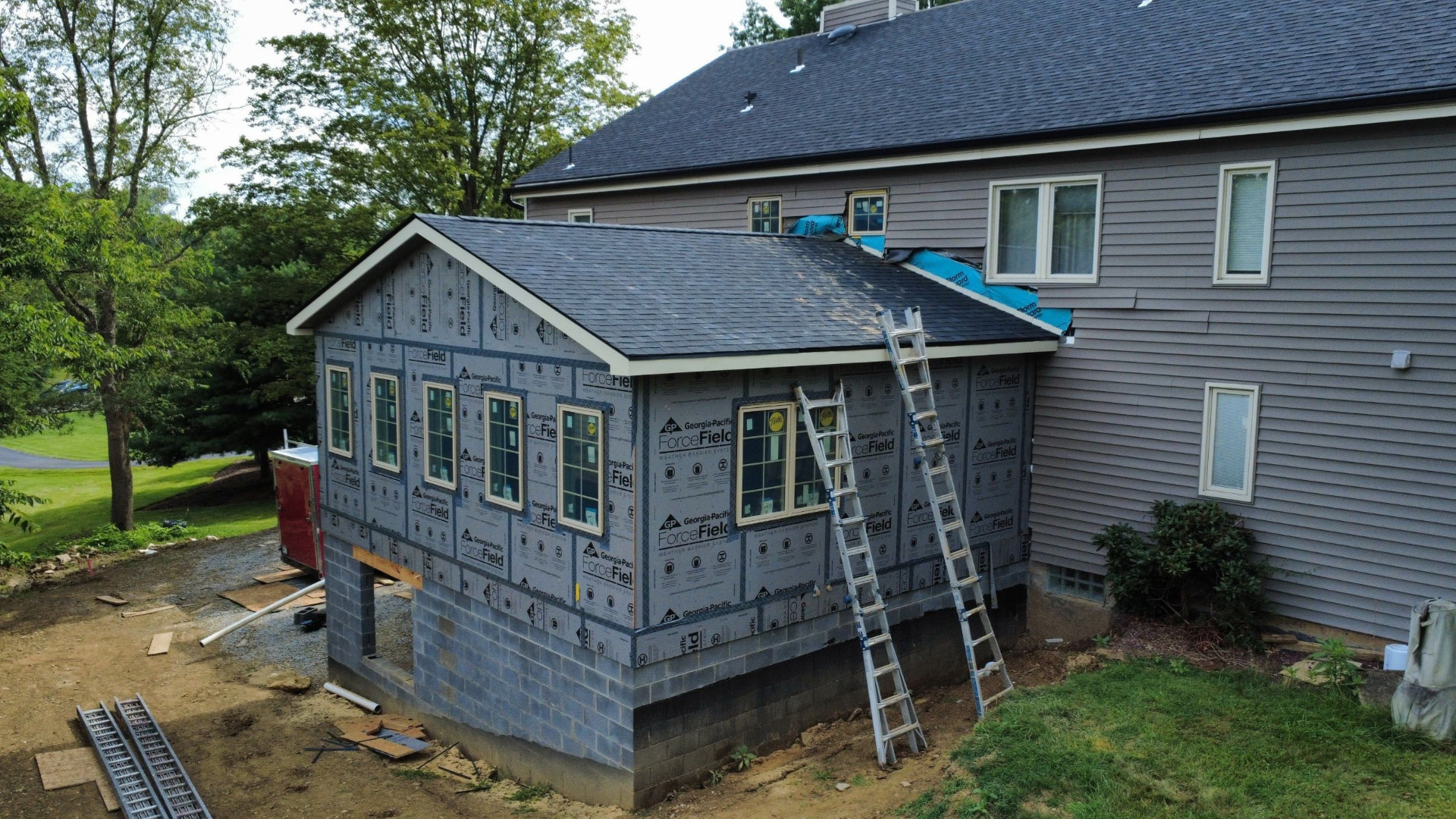 Home addition with new shingle roof and Georgia-Pacific ForceField sheathing ready for siding