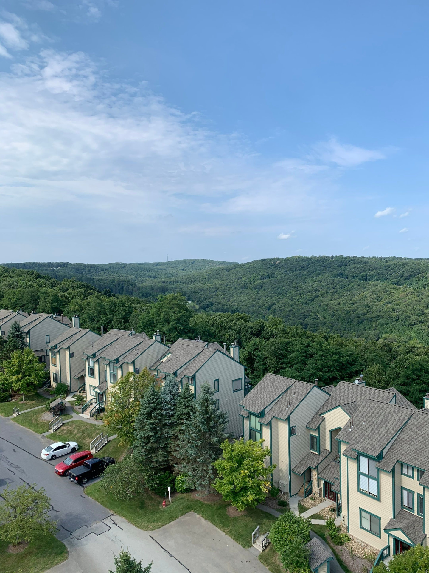 Aerial view of hilltop townhome community with new architectural shingle roofs